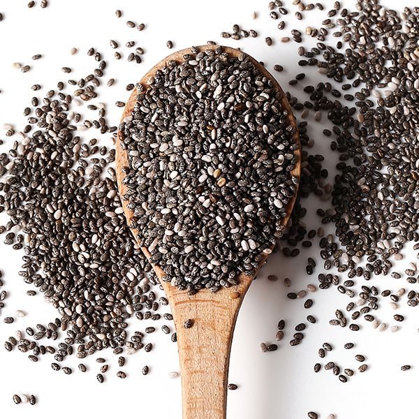 Black sesame and white sesame seed on wooden spoon
